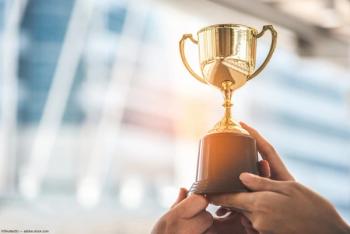 Hands holding up trophy Image credit: AdobeStock/Shutter2U