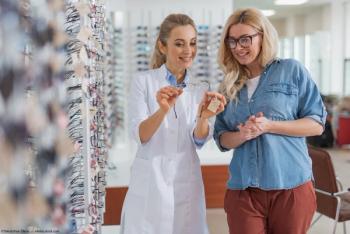 Optician showing client a pair of glasses Image credit: AdobeStock/YakobchukOlena
