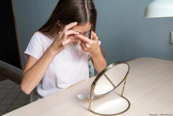 Child putting in contact lenses at desk Image credit: AdobeStock/irena_geo