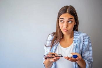 Teenager holding contact lenses in one hand and glasses in the other Image credit: AdobeStock/DraganaGordic
