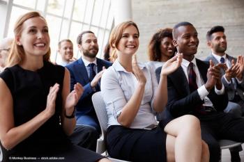 Audience Applauding Speaker At Business Conference (Adobe Stock / Monkey Business)