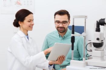optometrist using digital media to educate patient - Image credit: Adobe Stock / Syda Productions