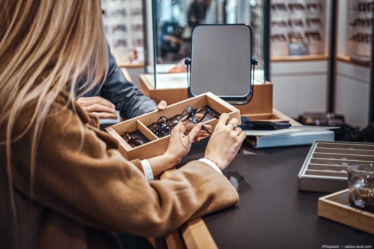 Woman at table in optical room shopping for glasses Image credit: ©Fxquadro - adobe.stock.com