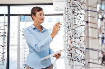 optician examines frames in financial report for Q3 earnings which sparked concern among eye care professionals - Nicholas F/peopleimages.com
