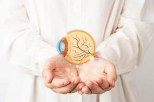 Doctor holding digital rendering of eye Image credit: AdobeStock/Orawan