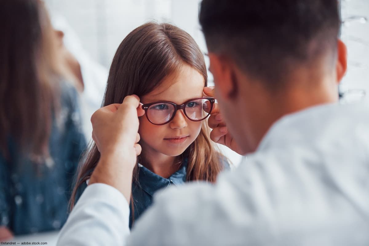 Optician fitting child with glasses Image credit: AdobeStock/standret