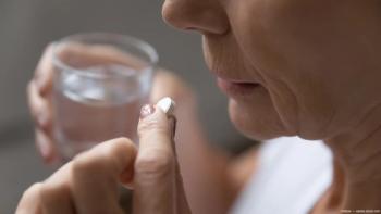 Older woman taking aspirin with water Image credit: ©fizkes - adobe.stock.com