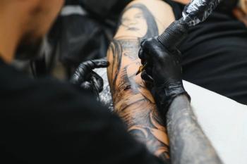 Man tattooing arm Image credit: AdobeStock/Serhii