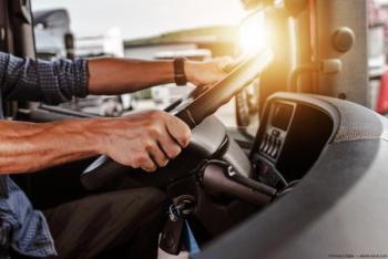 Man in drivers seat of commercial truck Image credit: AdobeStock/TomaszZajda
