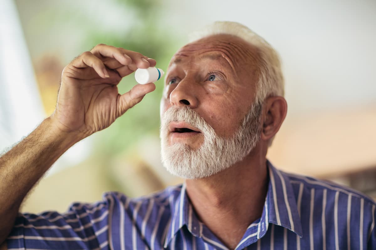 Man administering eye drops Image credit: AdobeStock/Mediteraneo