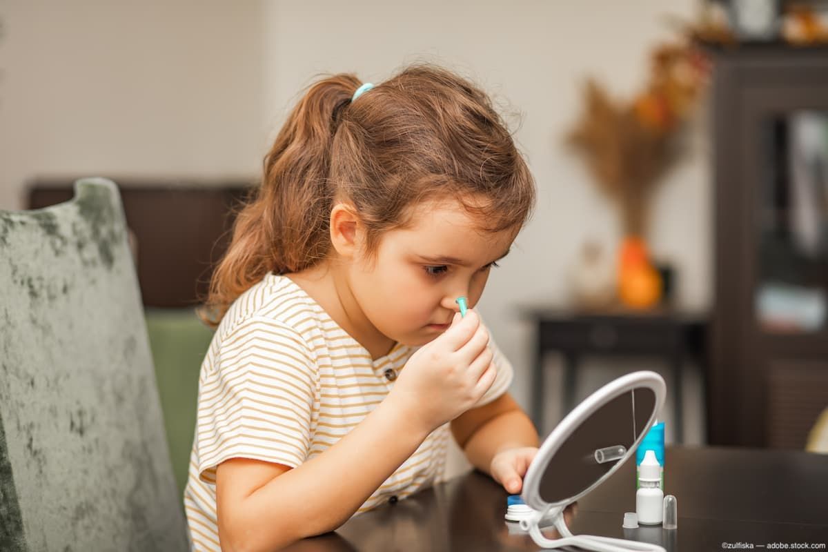 Child applying contact lens to eye Image credit: AdobeStock/zulfiska