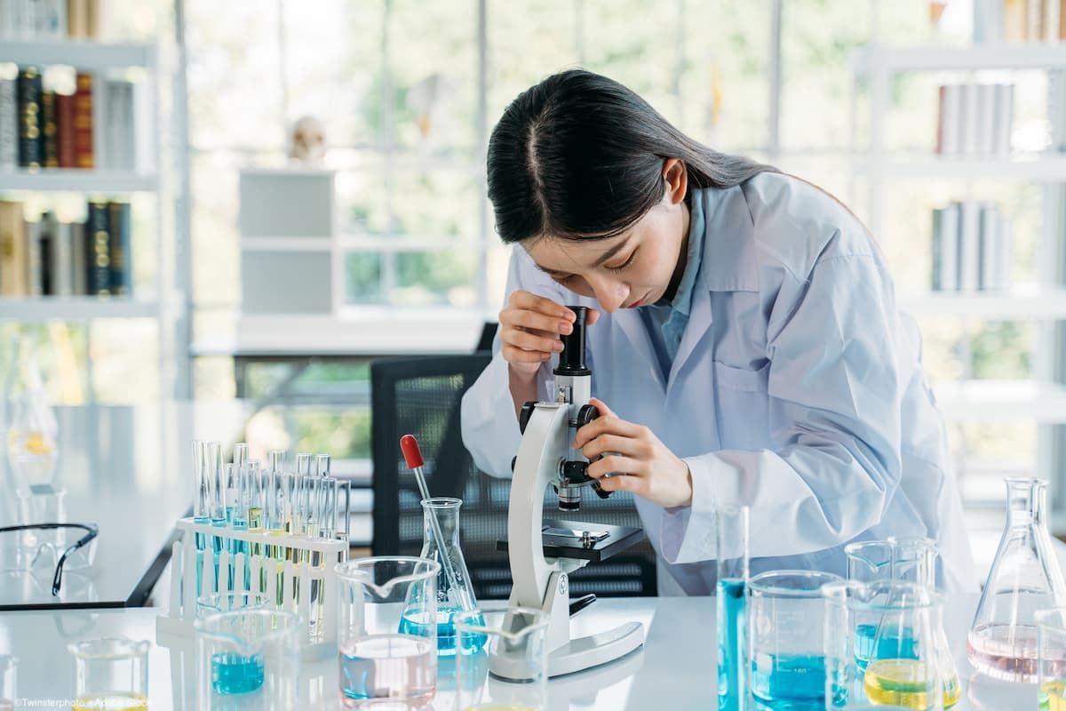 Woman looking through microscope