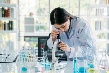 Woman looking through microscope