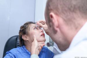 Physician administering eye drops for patient. Image credit: AdobeStock/NDSTOCK