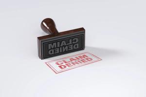 Rubber stamping that says Claim Denied on White Background | Image Credit: © Nirmal - stock.adobe.com