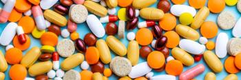 Different types of tablets, pills and capsules over blue background. above view. medicine concept. banner template. | © Andrii - stock.adobe.com (404267963)