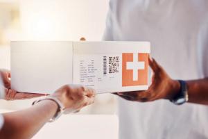 Pharmacy, delivery box and people hands for healthcare, package and ecommerce courier services. Shipping, pharmaceutical industry and telealth supplier giving mail, post or medicine to person at door | © Courtney/peopleimages.com - stock.adobe.com