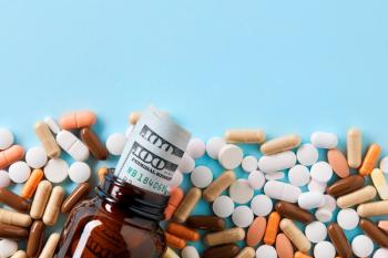 USD dollar bills in a drug bottle over the medical pills. Medicine, healthcare industry and drug trafficking concept. Overhead macro view with copy space - Image credit: Cagkan | stock.adobe.com