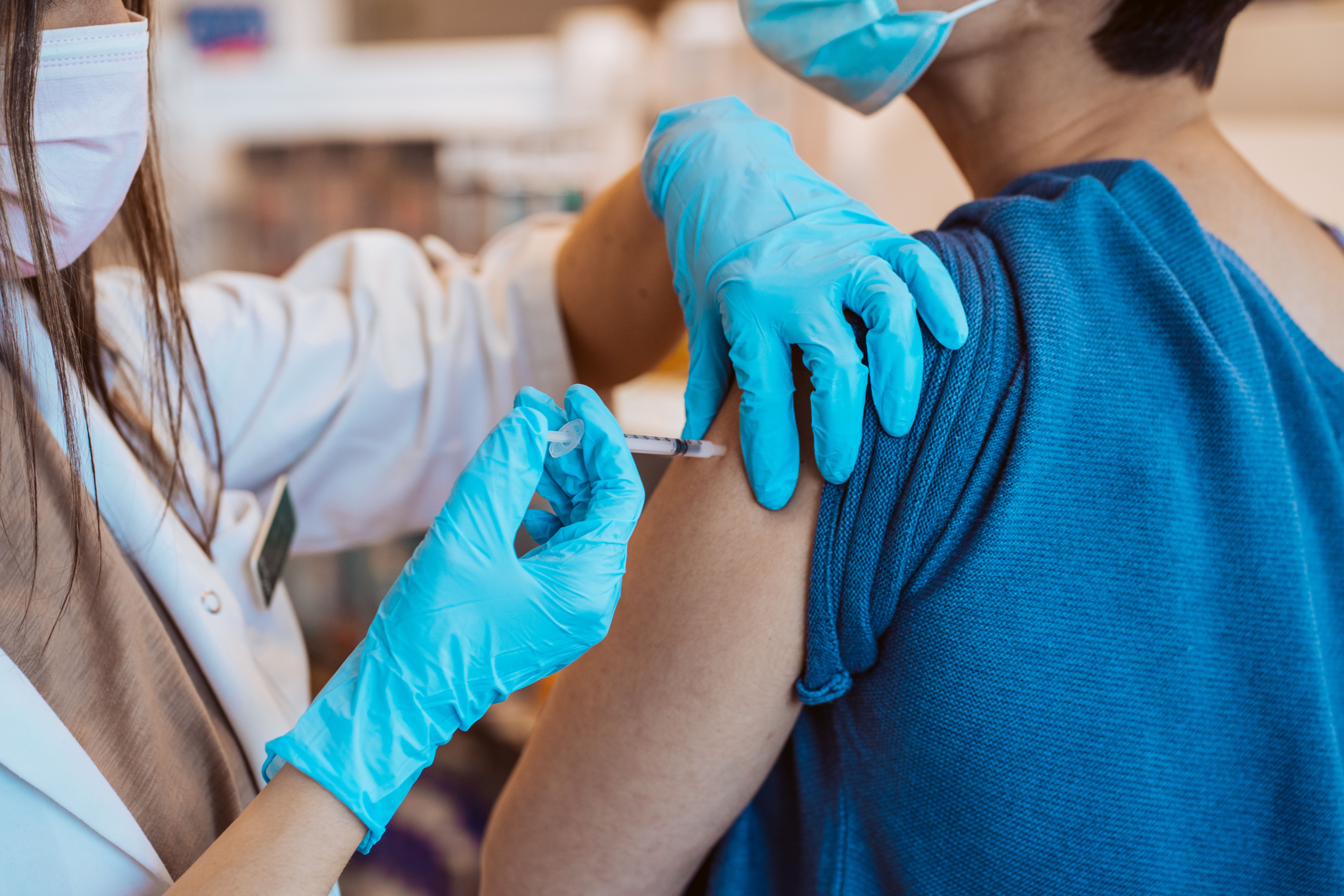 Young woman receiving the vaccine for the virus caused by covid 19. Immunization of the population. Fight against the virus - Image credit: lubero | stock.adobe.com
