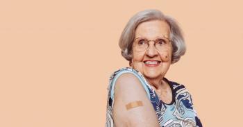 Portrait of a smiling elderly grandmother after receiving a vaccine. Elder woman showing her bandaged arm after receiving vaccination.
