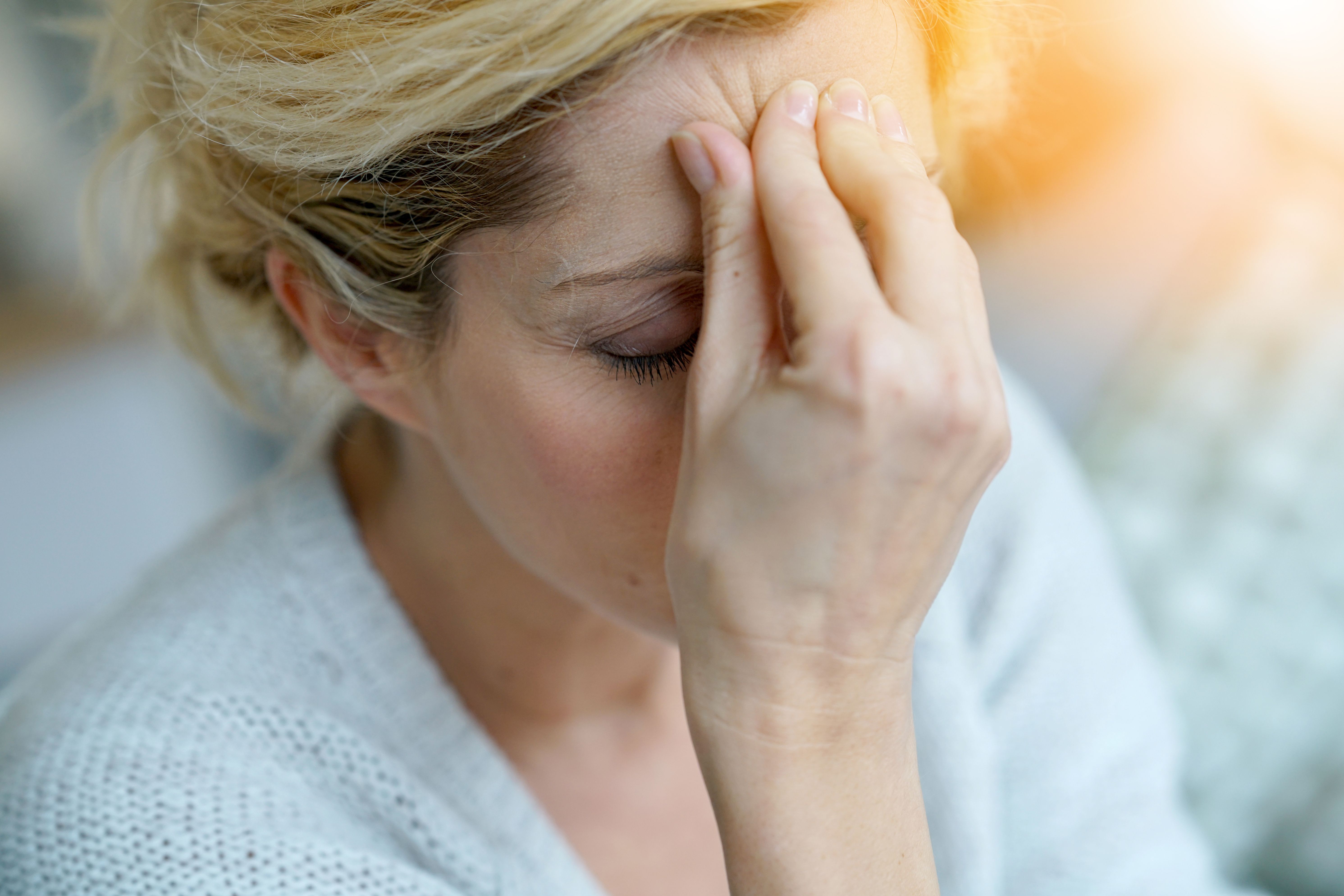Woman experiencing migraine-related pain -- Image credit: goodluz | stock.adobe.com