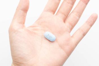 Woman holding dose of oral PrEP