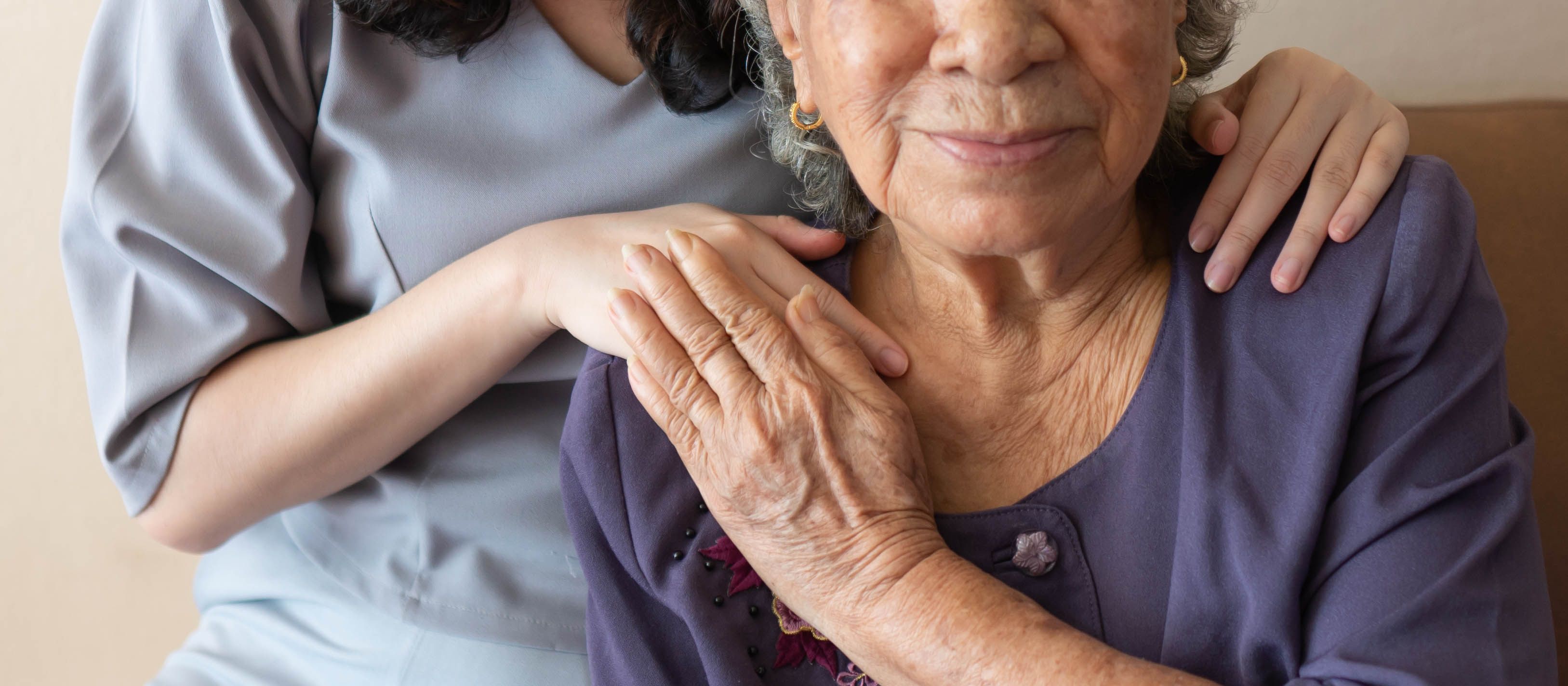 Friendly relationship between caregiver and happy eldery woman during nursing at home. Senior services and geriatric care concept - Image credit: Orawan | stock.adobe.com