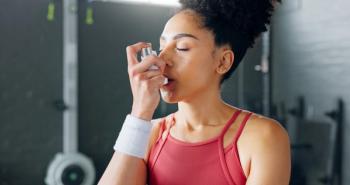 Exercise woman, asthma inhaler breathe at gym with fitness coach for chest relief and wellness. Black woman anxiety, asma attack sitting on floor at training workout for body health in Los Angeles - Image credit: N Felix/peopleimages.com | stock.adobe.com