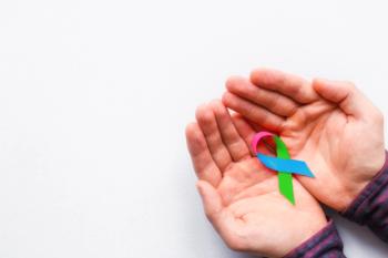 Man holding a rare disease awareness ribbon -- Image credit: itakdalee | stock.adobe.com