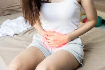 Woman experiencing UTI-related pain -- Image credit: 220 Selfmade studio | stock.adobe.com