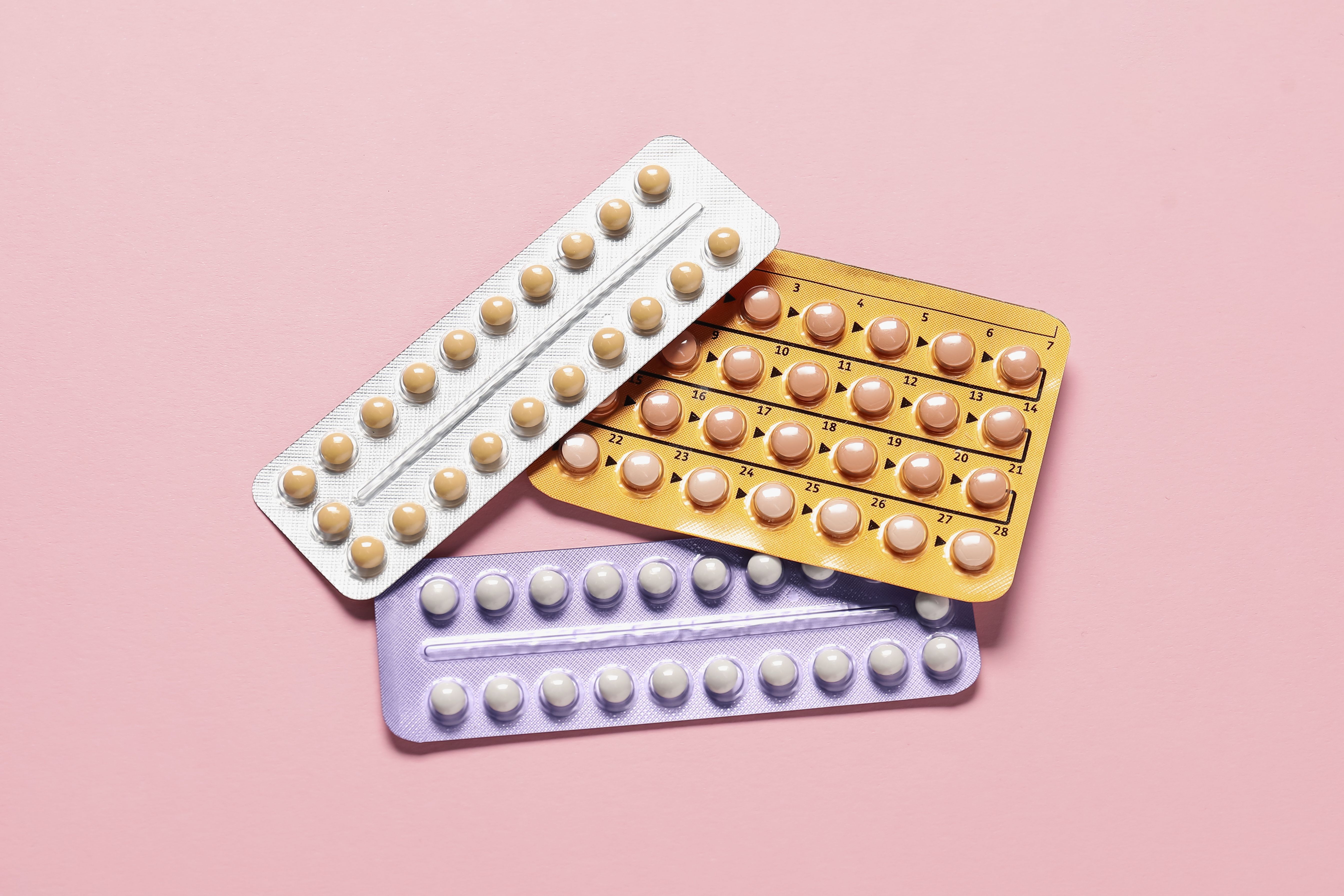 Blisters of oral contraceptive pills on pink background, flat lay | Image Credit: New Africa | stock.adobe.com