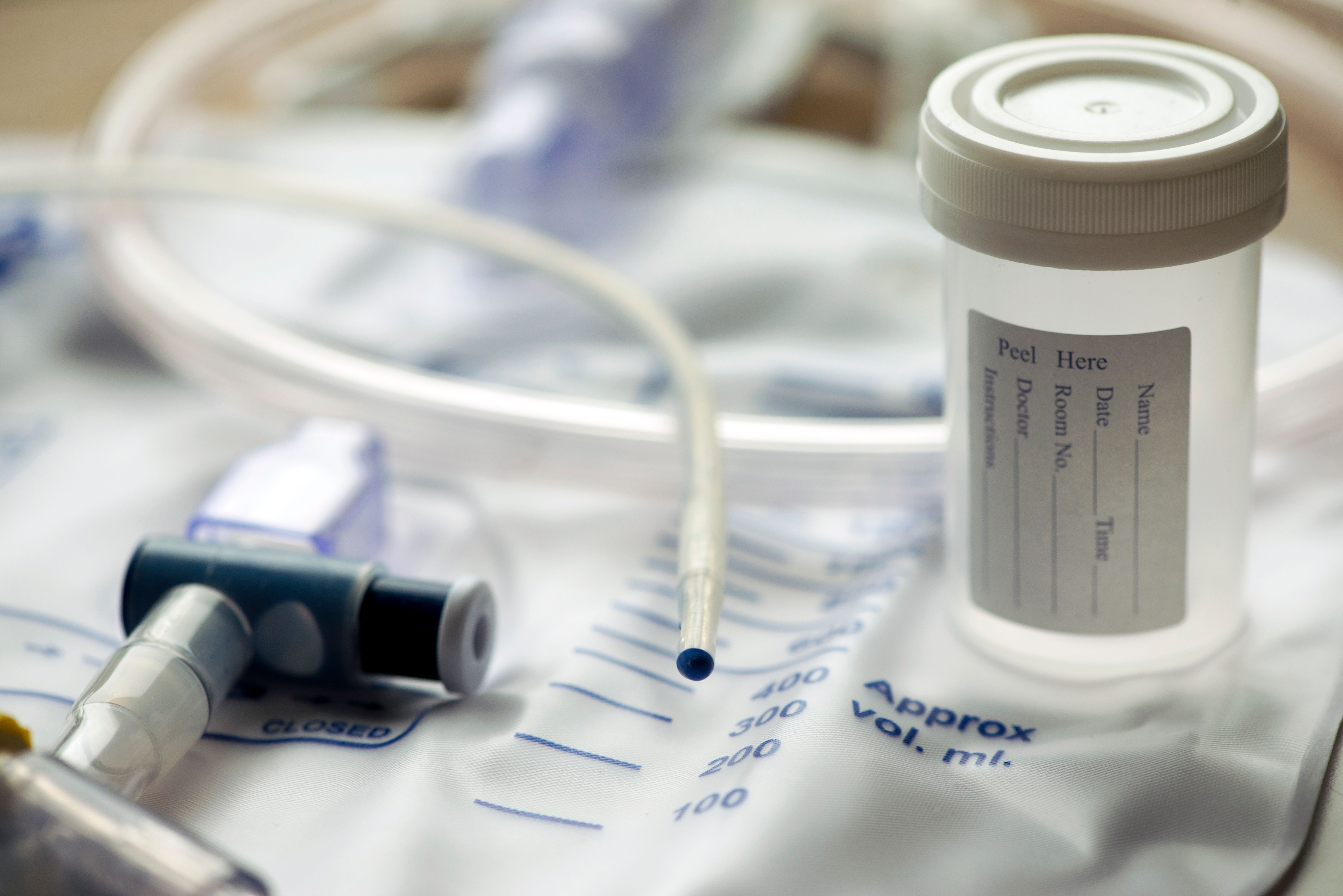 Urinary Catheter And Sample Cup - Image credit: Sherry Young | stock.adobe.com