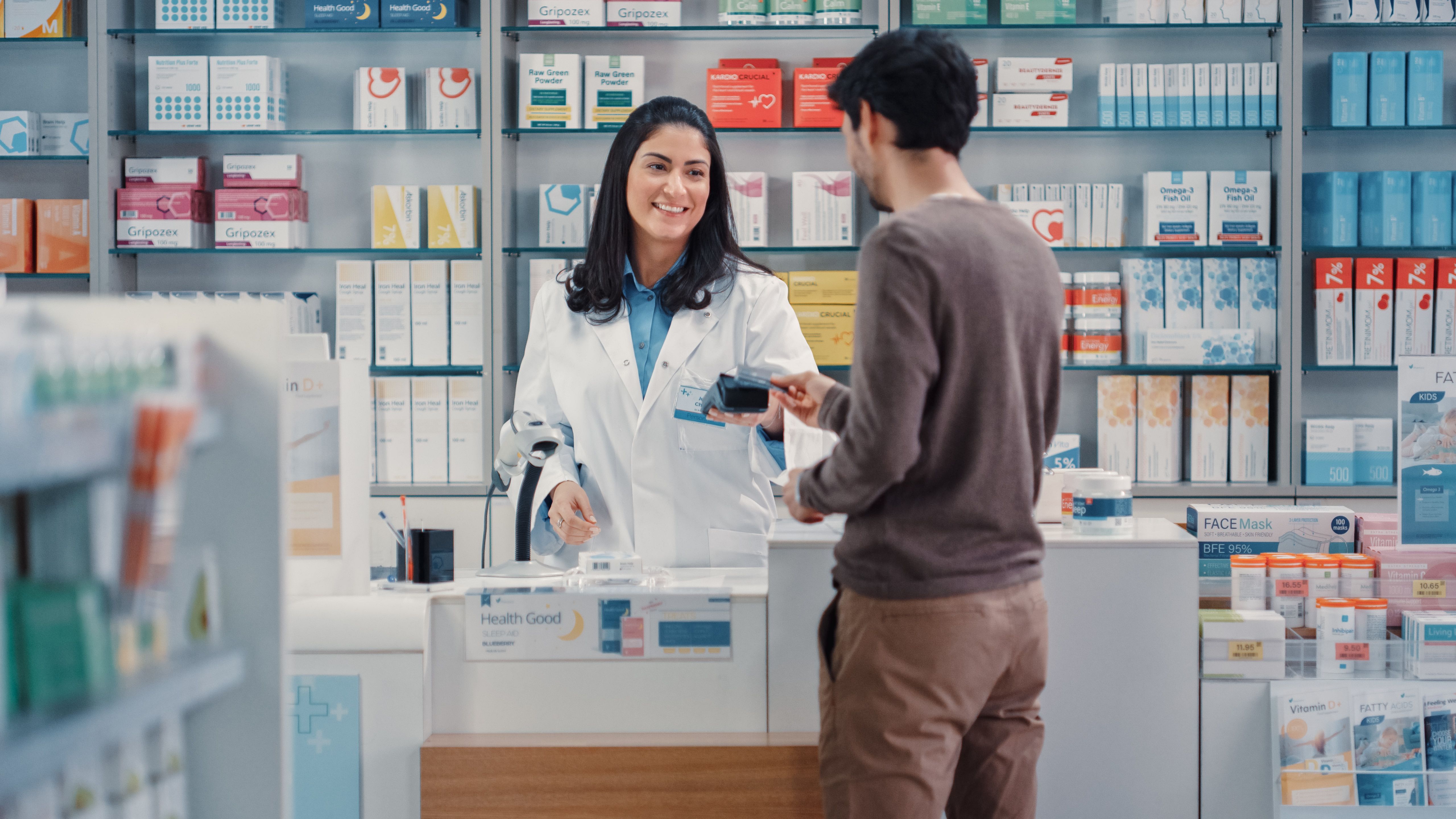 Pharmacist and patient in a community pharmacy -- Image credit: Gorodenkoff | stock.adobe.com
