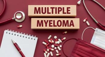 Multiple Myeloma diagnosis blocks are surrounded by medical supplies including pills, a stethoscope, and a notebook on a deep red surface. | Image Credit: Sam | adobe.stock.com
