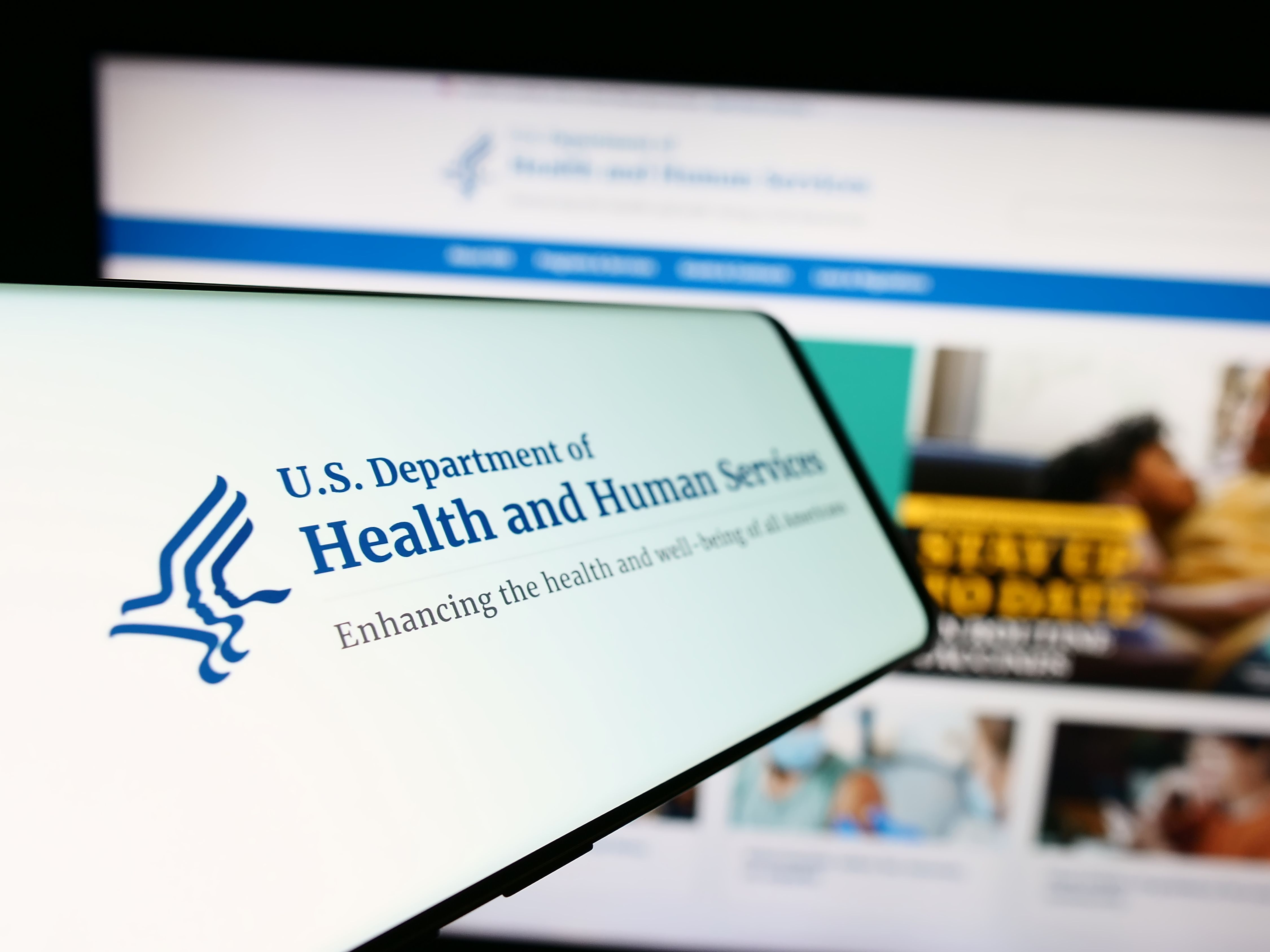 Mobile phone with logo of American Department of Health and Human Services | Image Credit: © Timon - stock.adobe.com 