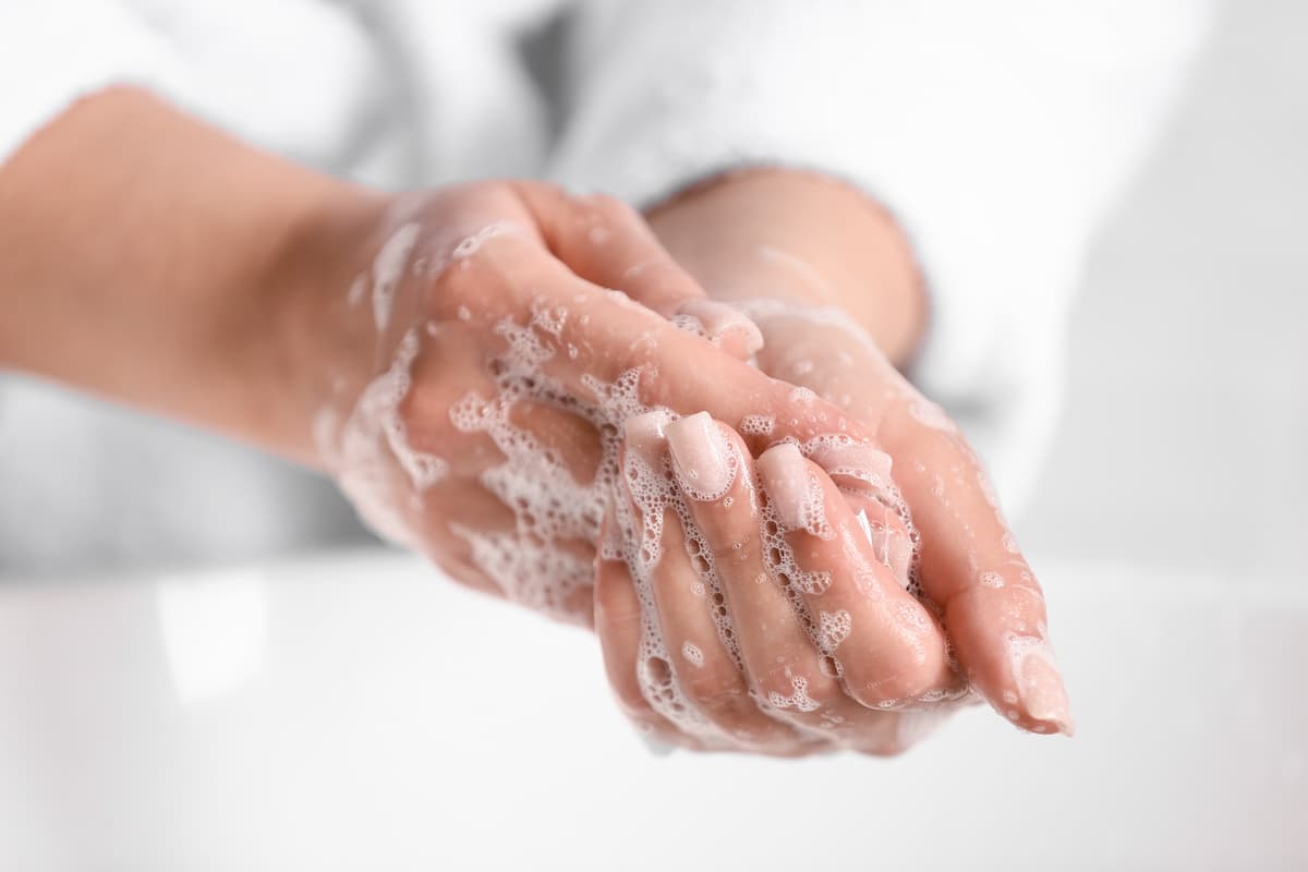 Woman washing hands in bathroom