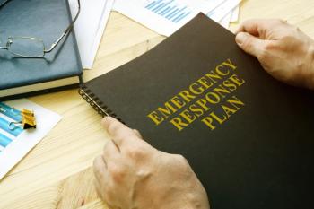 Man open disaster and emergency response plan for reading -  Image credit: Vitalii Vodolazskyi | stock.adobe.com 