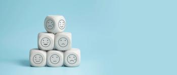 world mental health day concept or feedback rating and positive customer review, wood cube stacking with emotion face icon on blue background - Image credit: LAONG | stock.adobe.com