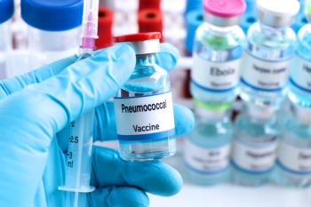 Gloved hand holding vaccine vial and syringe | Image Credit: © kittisak - stock.adobe.com