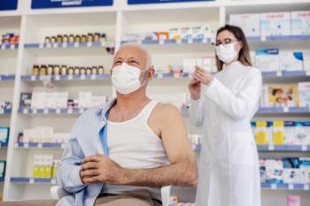 Therapy in a nursing home pharmacy. Female pharmacist gives therapy to a senior man who is sitting on a chair and has taken off his shirt. Vaccination, corona virus breaking news - Image credit: dusanpetkovic1 | stock.adobe.com