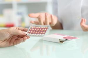 Girl buying contraceptive pills in a pharmacy | Image Credit: Antonioguillem - stock.adobe.com