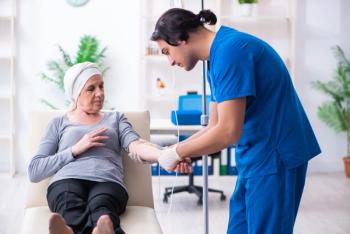 Pharmacist administering IV in patient -- Image credit: Elnur | stock.adobe.com
