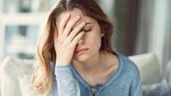 Young woman with headache | Image credit: Sebra - stock.adobe.com
