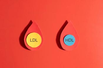 High cholesterol concept. LDL cholesterol with yellow spherical particles and HDL cholesterol with blue spherical particles inside blood droplets on red background. Cardiovascular disease problem