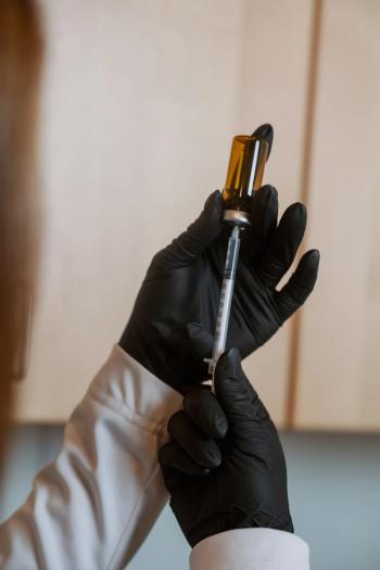 Pharmacist preparing an injectable drug -- Image credit: Amanda | stock.adobe.com