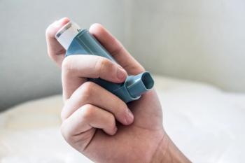 Man holding asthma inhaler