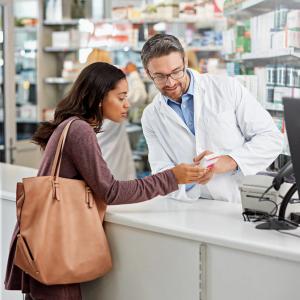 Pharmacist discussing prescription with patient -- Image credit: ReeseFullyOwned/peopleimages.com | stock.adobe.com