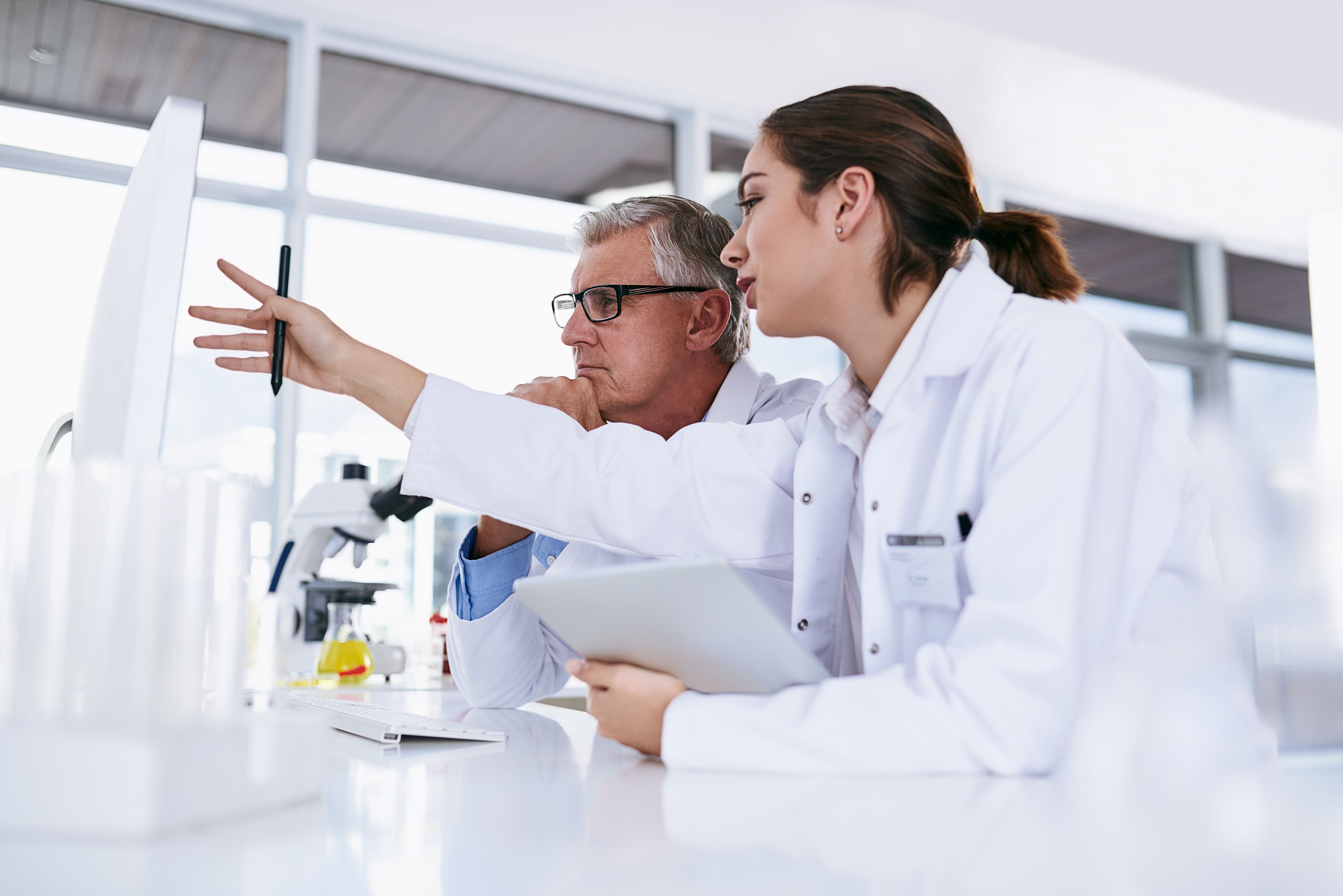 Pharmacists discussing medical research -- Image credit: Ruan J/peopleimages.com | stock.adobe.com 