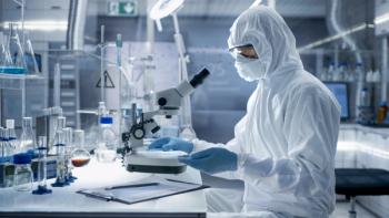 In a Secure High Level Laboratory Scientists in a Coverall Conducting a Research. Chemist Adjusts Samples in a Petri Dish with Pincers. | Image Credit: Gorodenkoff | stock.adobe.com