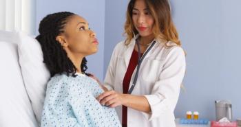doctor listening to heart and lungs of black patient in bed | Image Credit: rocketclips - stock.adobe.com